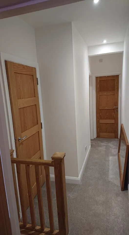 loft conversion with wooden stairs and door